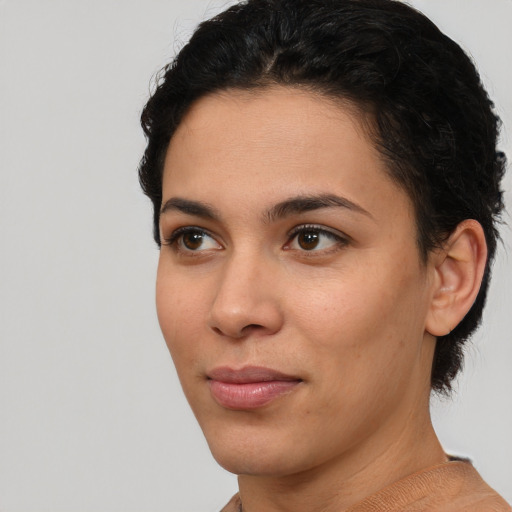 Joyful latino young-adult female with short  brown hair and brown eyes