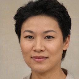 Joyful asian adult female with short  brown hair and brown eyes