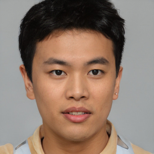 Joyful asian young-adult male with short  brown hair and brown eyes