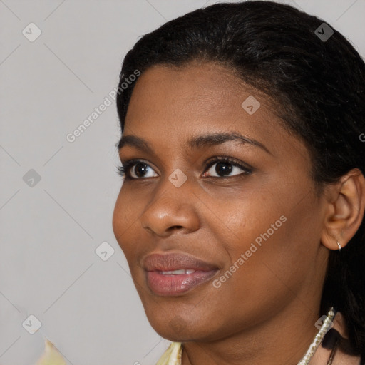 Joyful black young-adult female with short  black hair and brown eyes