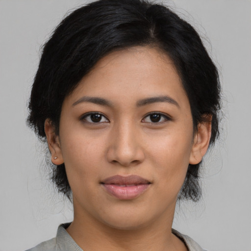 Joyful latino young-adult female with medium  black hair and brown eyes