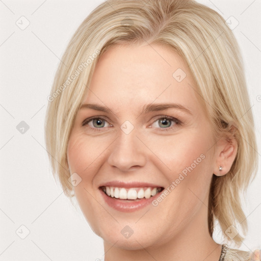 Joyful white young-adult female with medium  blond hair and blue eyes