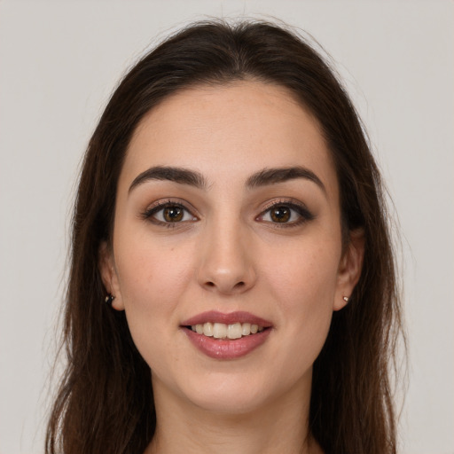 Joyful white young-adult female with long  brown hair and brown eyes