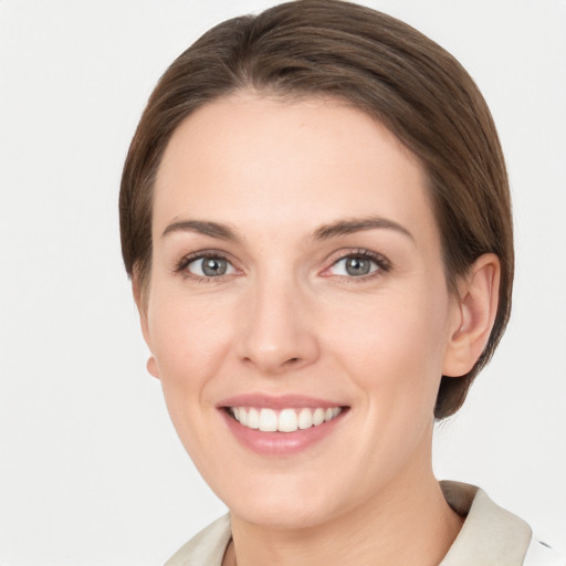 Joyful white young-adult female with medium  brown hair and grey eyes