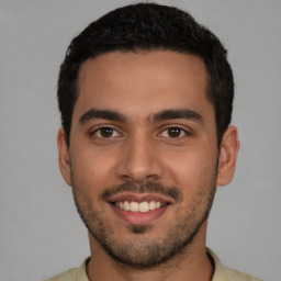 Joyful white young-adult male with short  black hair and brown eyes