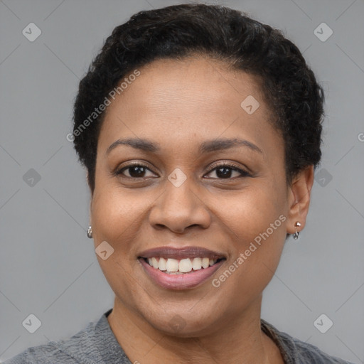 Joyful black adult female with short  brown hair and brown eyes