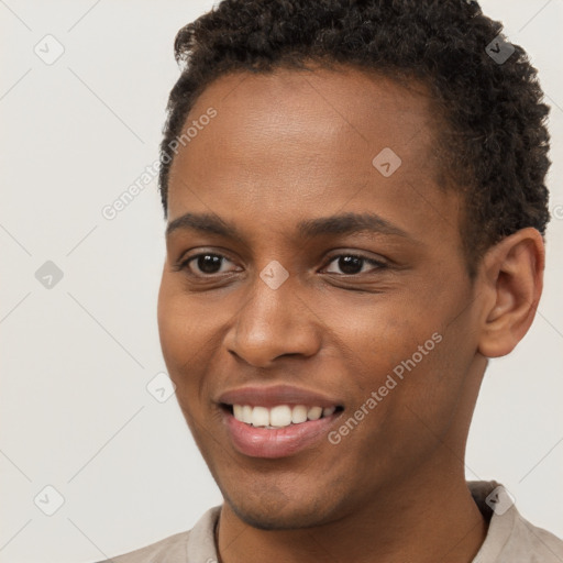 Joyful black young-adult male with short  brown hair and brown eyes