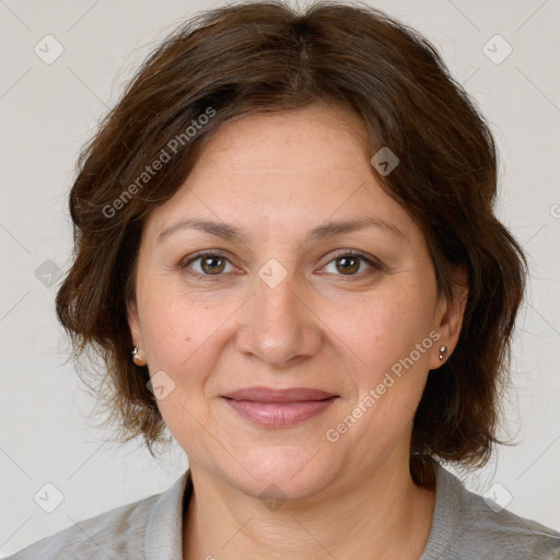 Joyful white adult female with medium  brown hair and grey eyes