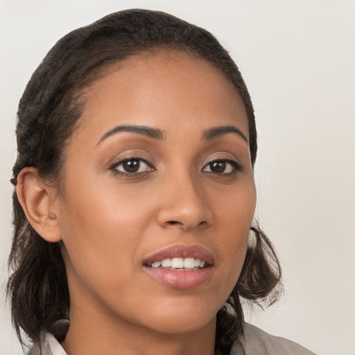 Joyful latino young-adult female with medium  brown hair and brown eyes