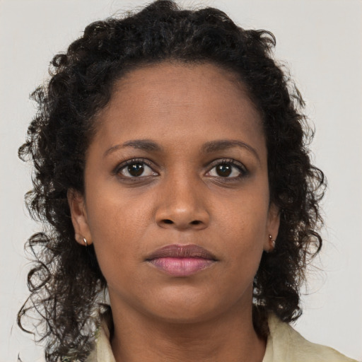 Neutral black young-adult female with long  brown hair and brown eyes