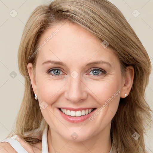 Joyful white young-adult female with long  brown hair and blue eyes