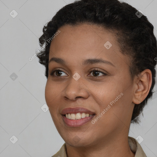 Joyful black young-adult female with short  brown hair and brown eyes