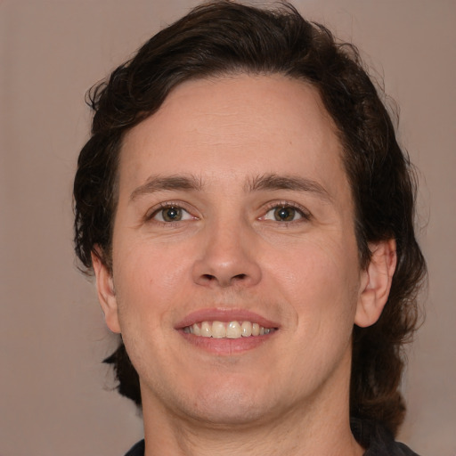 Joyful white young-adult male with medium  brown hair and brown eyes