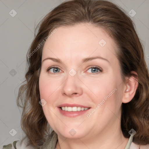 Joyful white adult female with medium  brown hair and blue eyes