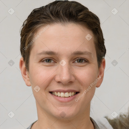 Joyful white young-adult female with short  brown hair and grey eyes