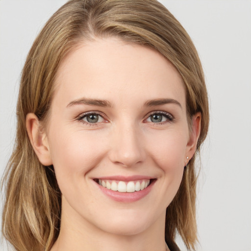 Joyful white young-adult female with long  brown hair and grey eyes