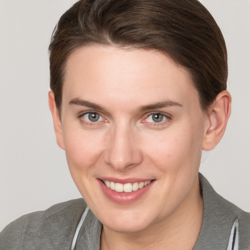 Joyful white young-adult female with short  brown hair and grey eyes