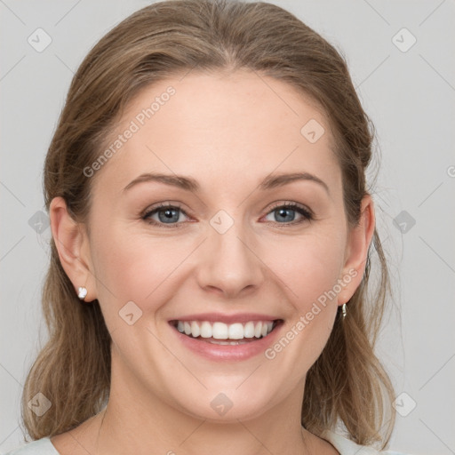 Joyful white young-adult female with medium  brown hair and grey eyes