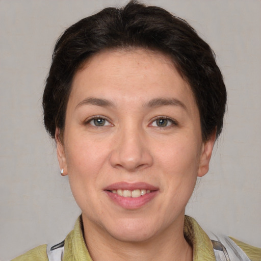 Joyful white adult female with short  brown hair and brown eyes