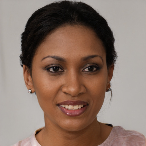 Joyful black young-adult female with short  brown hair and brown eyes