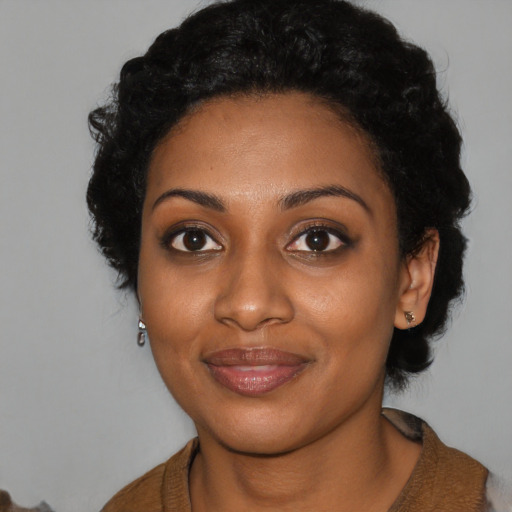Joyful black young-adult female with medium  black hair and brown eyes
