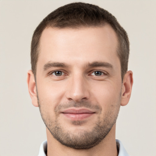 Joyful white young-adult male with short  brown hair and brown eyes