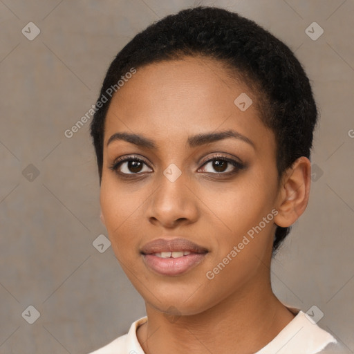 Joyful black young-adult female with short  black hair and brown eyes