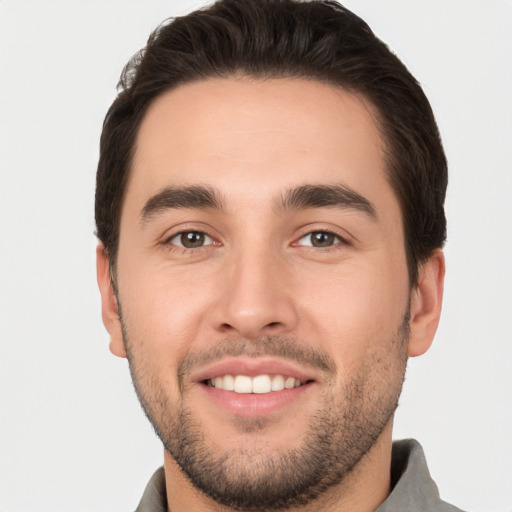 Joyful white young-adult male with short  brown hair and brown eyes