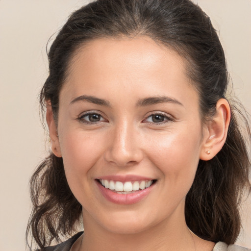 Joyful white young-adult female with medium  brown hair and brown eyes