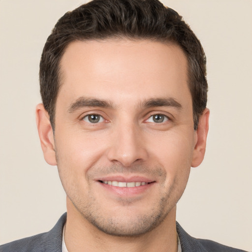 Joyful white young-adult male with short  brown hair and brown eyes