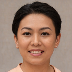 Joyful asian young-adult female with short  brown hair and brown eyes