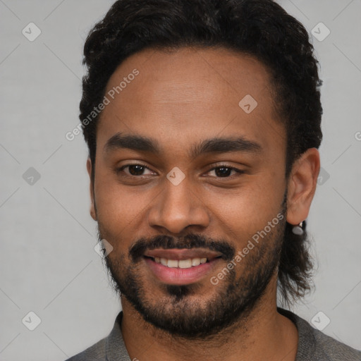 Joyful black young-adult male with short  black hair and brown eyes