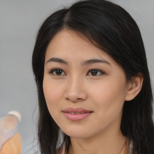 Joyful asian young-adult female with long  brown hair and brown eyes