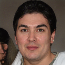 Joyful white adult male with short  black hair and brown eyes