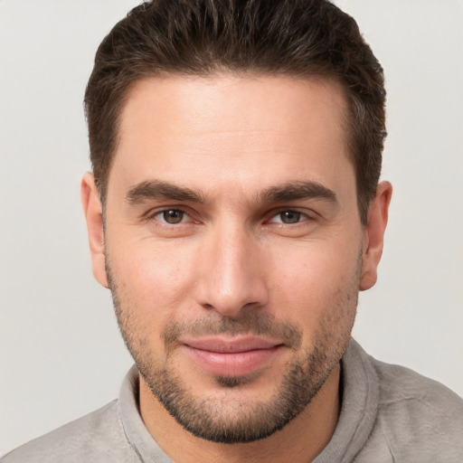 Joyful white young-adult male with short  brown hair and brown eyes