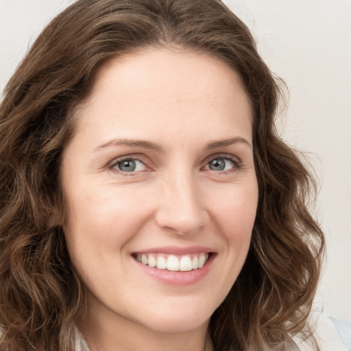 Joyful white young-adult female with long  brown hair and green eyes