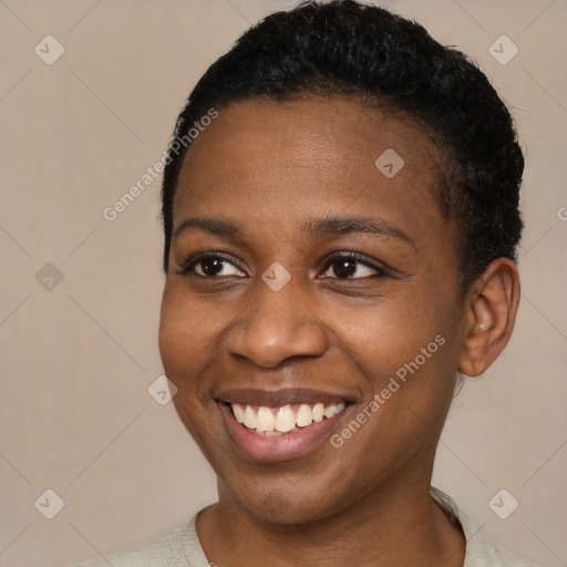 Joyful black young-adult female with short  black hair and brown eyes