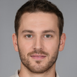 Joyful white young-adult male with short  brown hair and grey eyes