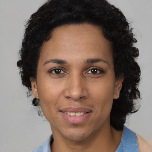Joyful latino adult female with short  brown hair and brown eyes