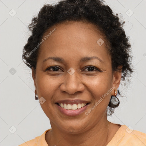 Joyful black adult female with short  brown hair and brown eyes