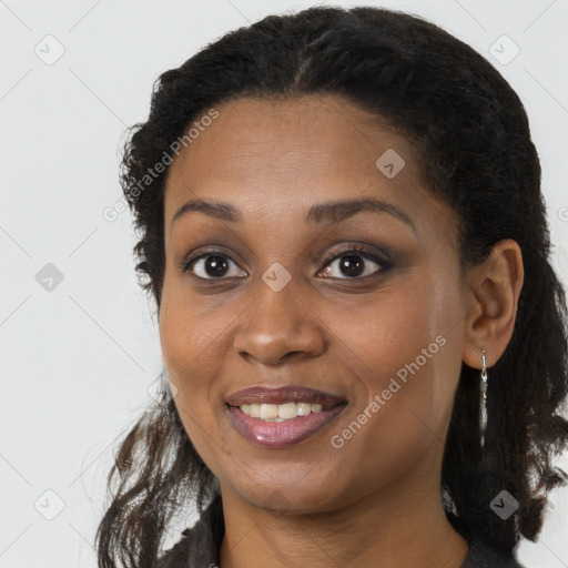 Joyful black young-adult female with long  brown hair and brown eyes