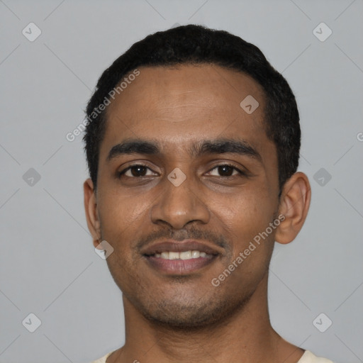 Joyful black young-adult male with short  black hair and brown eyes