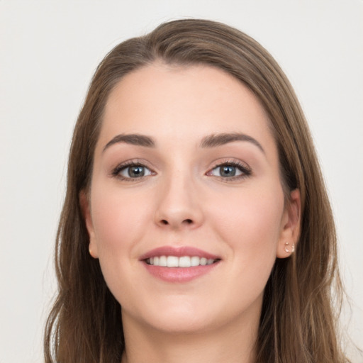 Joyful white young-adult female with long  brown hair and grey eyes