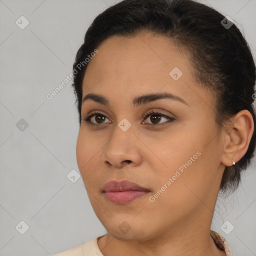 Joyful latino young-adult female with short  brown hair and brown eyes