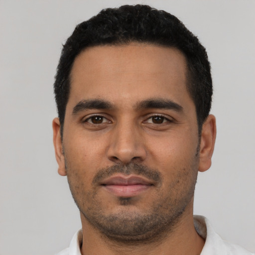 Neutral latino young-adult male with short  black hair and brown eyes