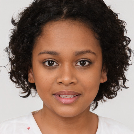 Joyful black child female with medium  brown hair and brown eyes