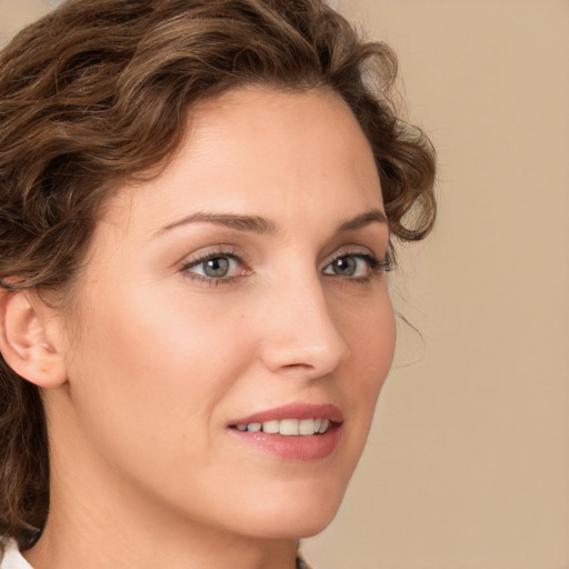 Joyful white young-adult female with medium  brown hair and green eyes