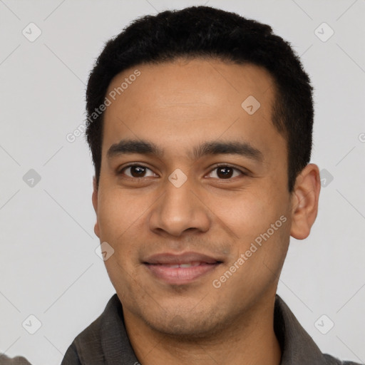 Joyful latino young-adult male with short  black hair and brown eyes