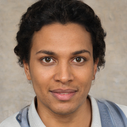 Joyful black young-adult male with short  brown hair and brown eyes