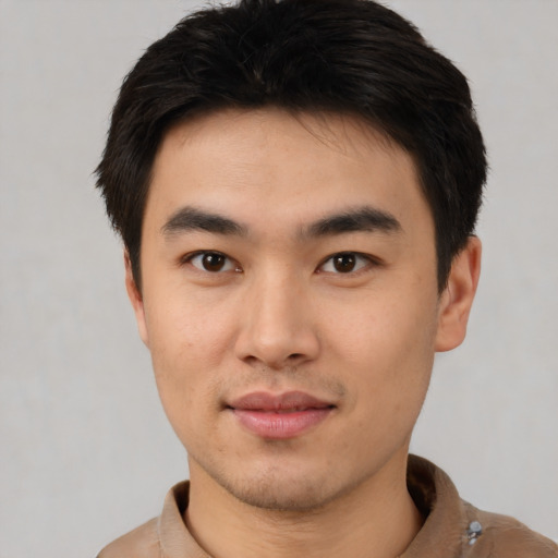 Joyful asian young-adult male with short  brown hair and brown eyes